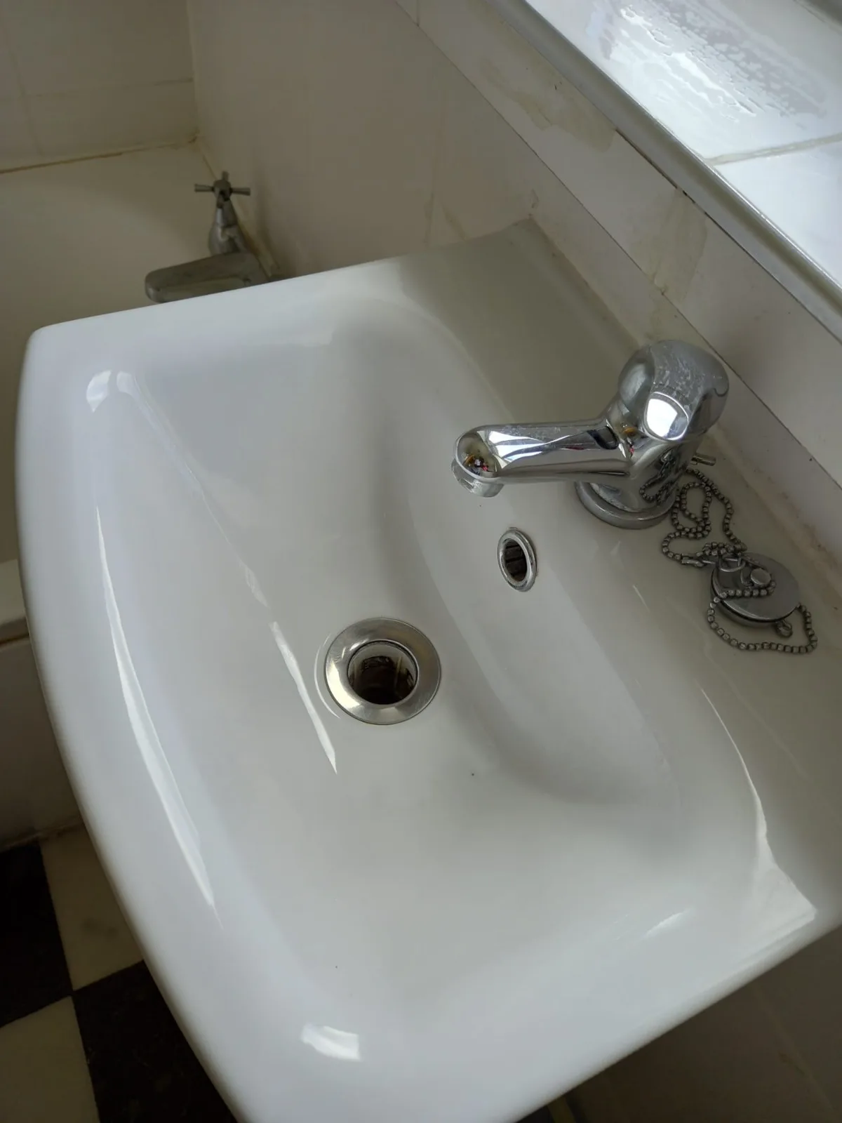 Bathroom sink and chrome fixtures polished